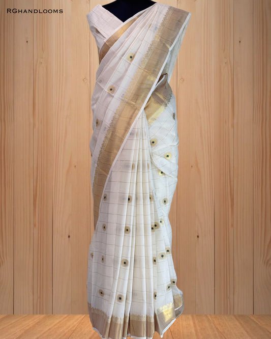handloom saree featuring a classic checked design with green buttas